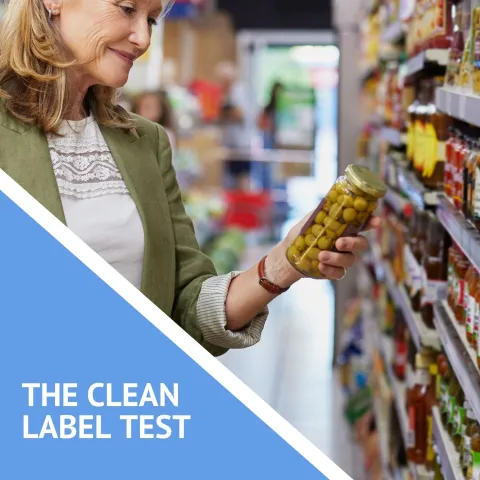 woman shopping in a grocery aisle with the headline the clean label test
